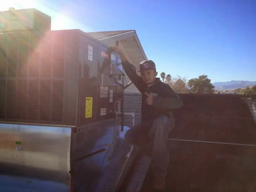 HVAC technician performing Boiler Repair on a rooftop unit in North Salem